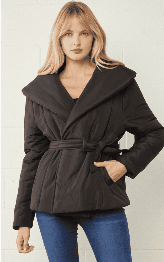Solid puffy belted jacket featuring self tie closure at waist. Button closure at front. Pockets at sides. Lined fully.Mediumweight.Material: 100% Polyester